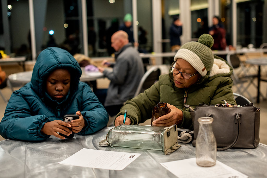 Community members fill out information about objects brought in for inclusion in the Field of Histories installation, photo by Natalie Tranelli Photography